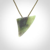 This is a lovely New Zealand Jade, pounamu niho drop pendant. It is bound with an adjustable khaki coloured cord which is length adjustable.